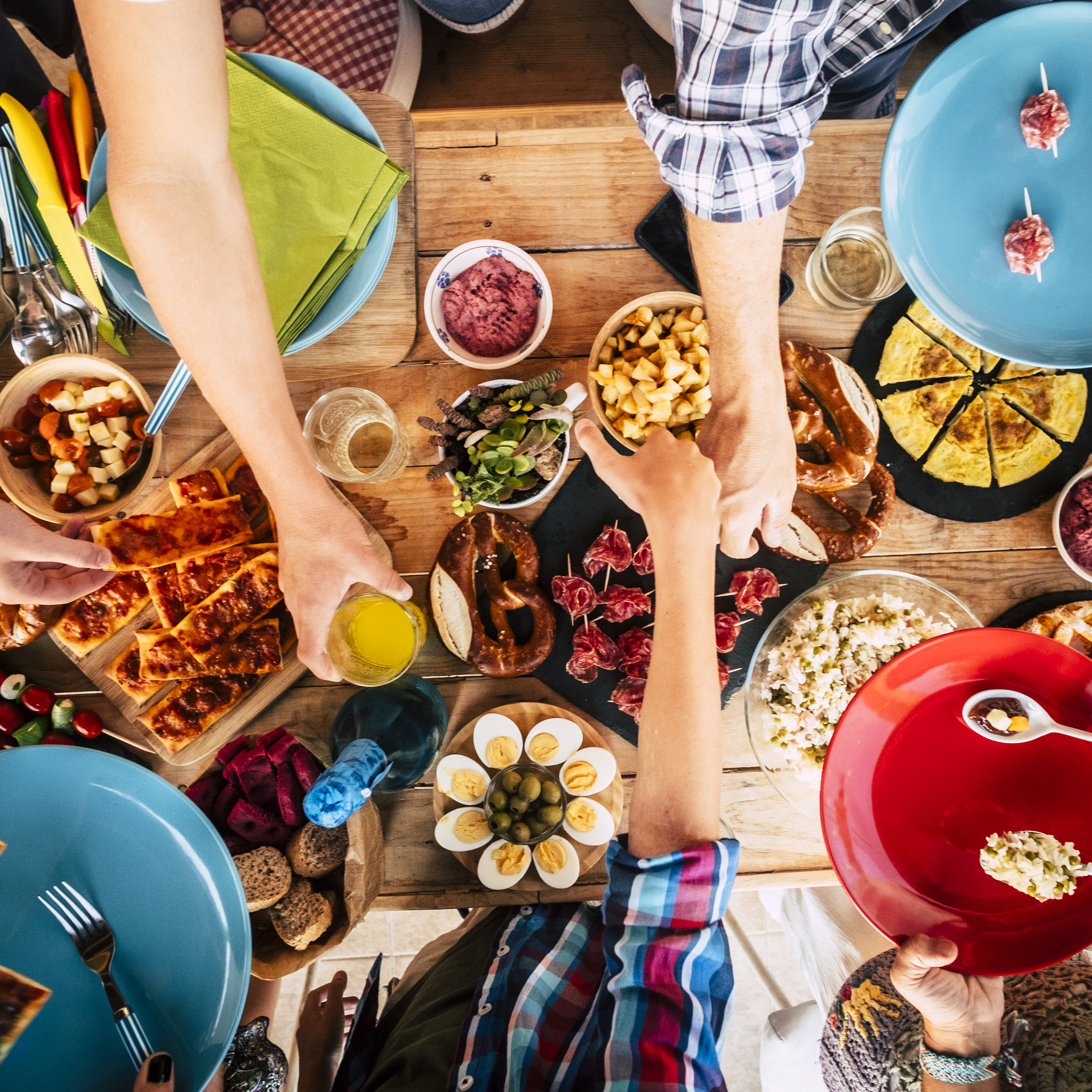Vertical view of group of friends family eating together on a wo